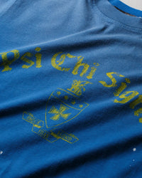 Pieces Brotherhood Tee faded blue, close-up of the Psi Chi Sigma crest print