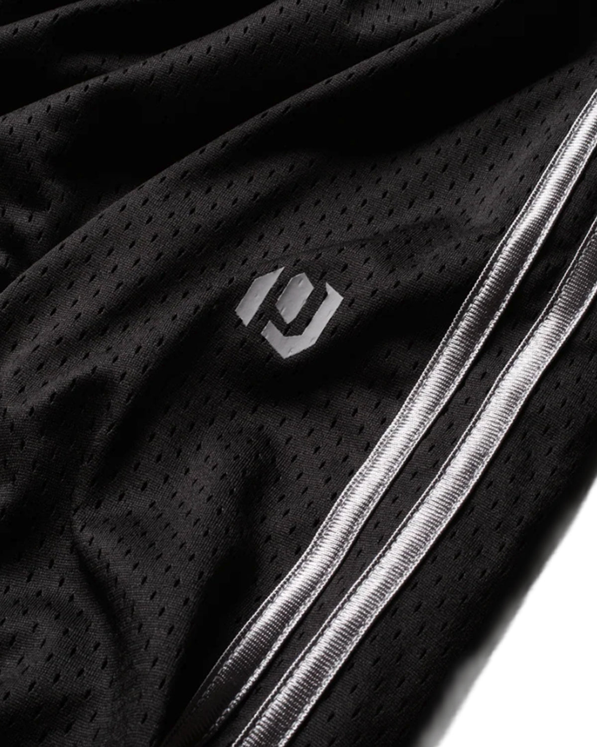 Pieces Hoop Long Shorts black, close-up of the PCS logo and white side stripes on the mesh