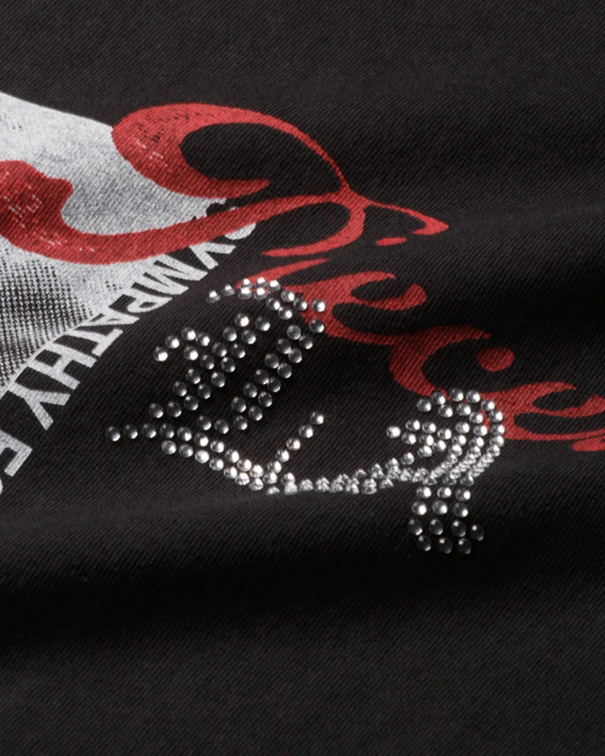 Pieces Sympathy Tee vintage black, close-up of red script and rhinestone lettering