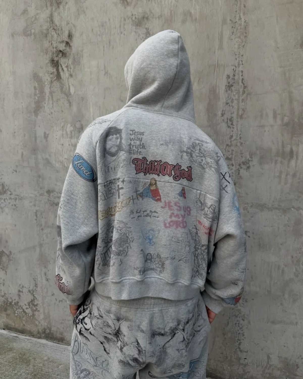 Model wearing Righteous Jesus My Lord grey zip up hoodie with hood up, back view