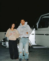 Two models standing beside a car wearing Righteous Jesus My Lord grey zip up hoodie
