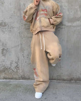Model wearing Righteous Sacred Heart brown sweatpants with matching zip up hoodie