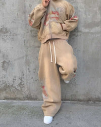 Model wearing Righteous Sacred Heart brown sweatpants with matching zip up hoodie
