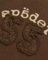 Sp5der 55 University Wide Leg Sweatpants brown, close-up of the Sp5der lettering and distressed 55 appliqué