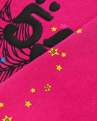 Sp5der Angel Number Hoodie pink, angled close-up of the puff numerals and yellow stars stamped with a small 5 logo