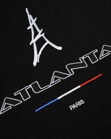 Sp5der Arraignee Tee black, close-up of the Eiffel Tower embroidery, ATLANTA wordmark, tricolour bar and PARIS lettering