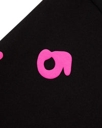 Sp5der Beluga Angel Number Hoodie black and pink, close-up of a single pink numeral printed on the sleeve