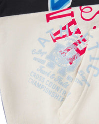 Sp5der Campers Field Zip Up Hoodie onyx, close-up of the pocket and bone colorblock panel