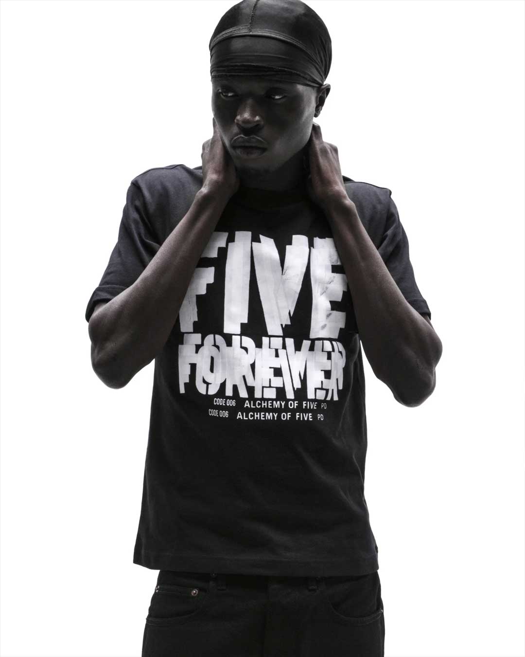 Sp5der Distort Tee onyx worn by a model, front view with FIVE FOREVER graphic