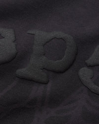 Sp5der Distressed OG Web V2 L/S granite black, close-up of the tonal puff Sp5der lettering