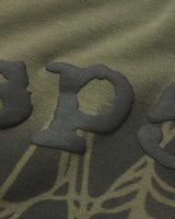 Sp5der Distressed OG Web V2 L/S olympian green, close-up of the distressed puff lettering