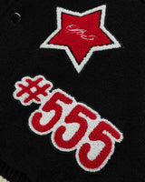 Sp5der District Cuntry Varsity Jacket black, close-up of the red star and #555 chenille patches