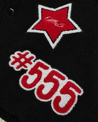Sp5der District Cuntry Varsity Jacket black, close-up of the red star and #555 chenille patches