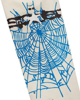 Sp5der Heavy Web Sweatpants foam cream, close-up of the blue spiderweb and Sp5der logo on the leg
