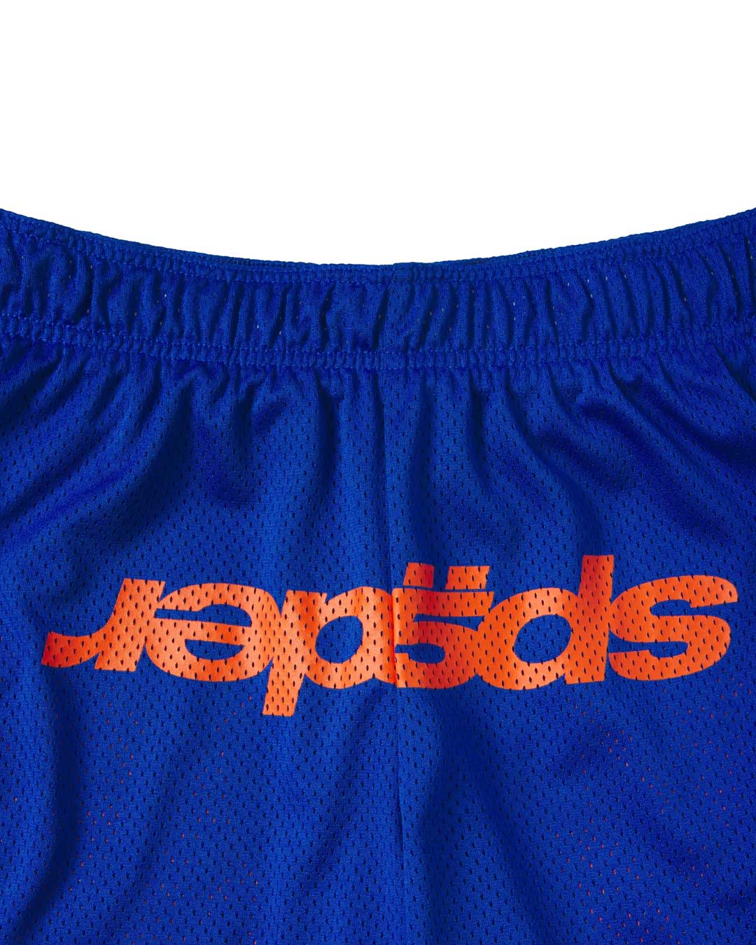Sp5der Mesh Double Layer Shorts blue, close-up of the elastic waistband and orange sp5der wordmark on blue mesh