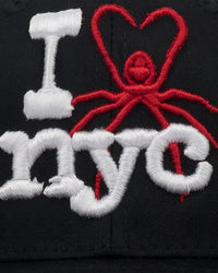 Sp5der NYC Baseball Cap black, close-up of the puff-embroidered spider heart and nyc lettering