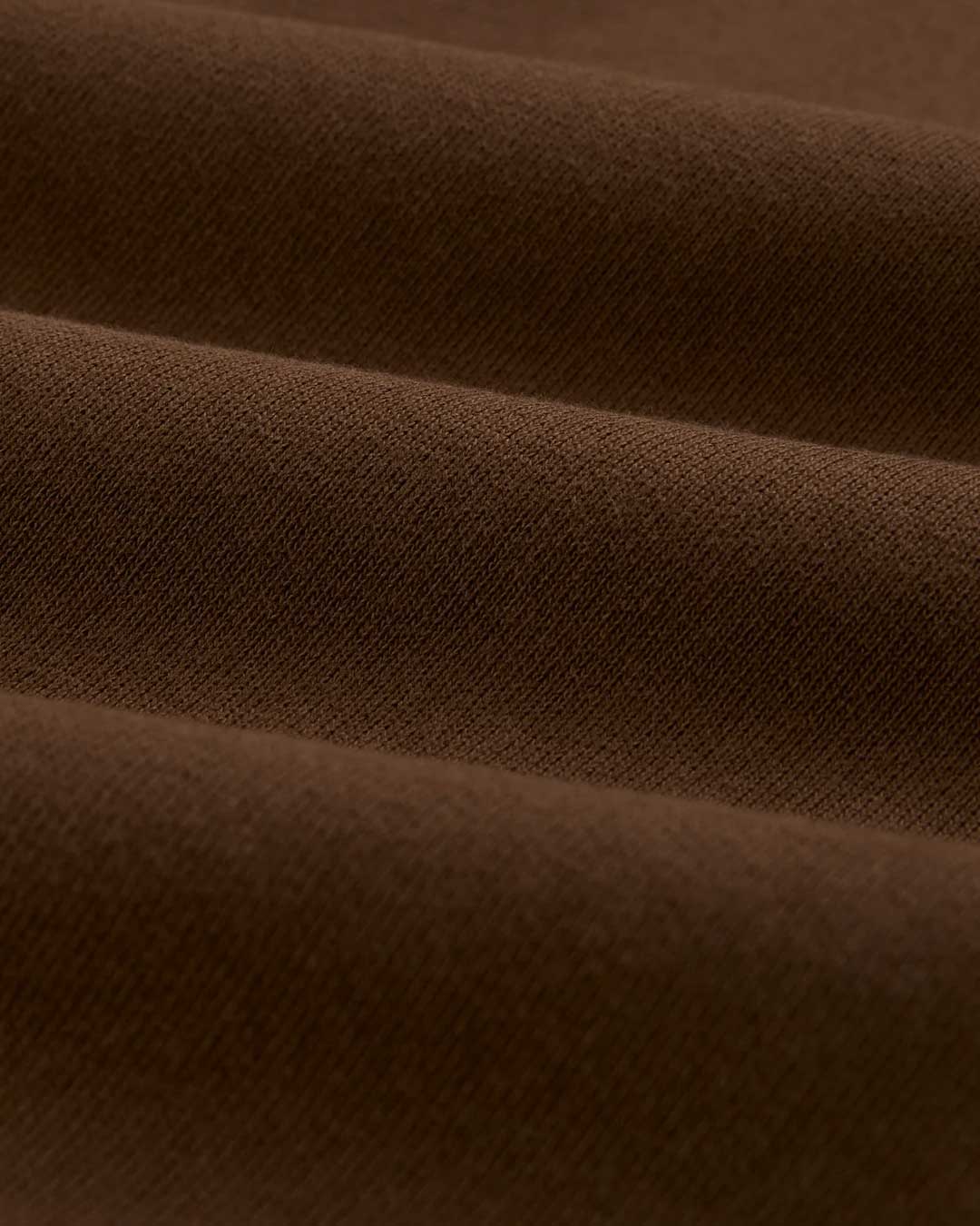 Sp5der OG Web Rhinestone Sweatpants brown, close-up of the brushed brown fleece fabric