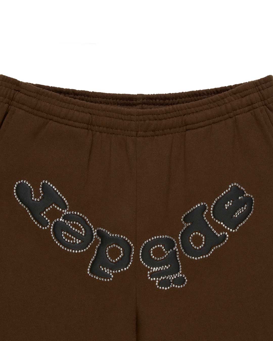 Sp5der OG Web Rhinestone Sweatpants brown, close-up of the full arched rhinestone wordmark below the elastic waistband