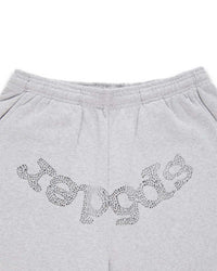 Sp5der Rhinestone Beluga V2 Wide Leg Sweatpants heather grey, close-up of the silver rhinestone sp5der wordmark below the elastic waistband