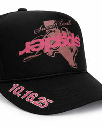 Sp5der Rodeo Texas Trucker Hat black, close-up of the pink Sp5der Texas graphic and 10.16.25 lettering