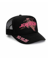 Sp5der Rodeo Texas Trucker Hat black, mesh-back trucker with pink Sp5der Texas graphic and 10.16.25 lettering, front view