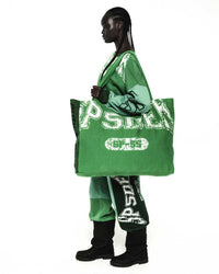 Sp5der Sp5 Jersey Tote Bag kelly green carried by a model, side view showing the oversized size