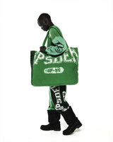 Sp5der Sp5 Jersey Tote Bag kelly green carried by a model, three-quarter view with the front lettering