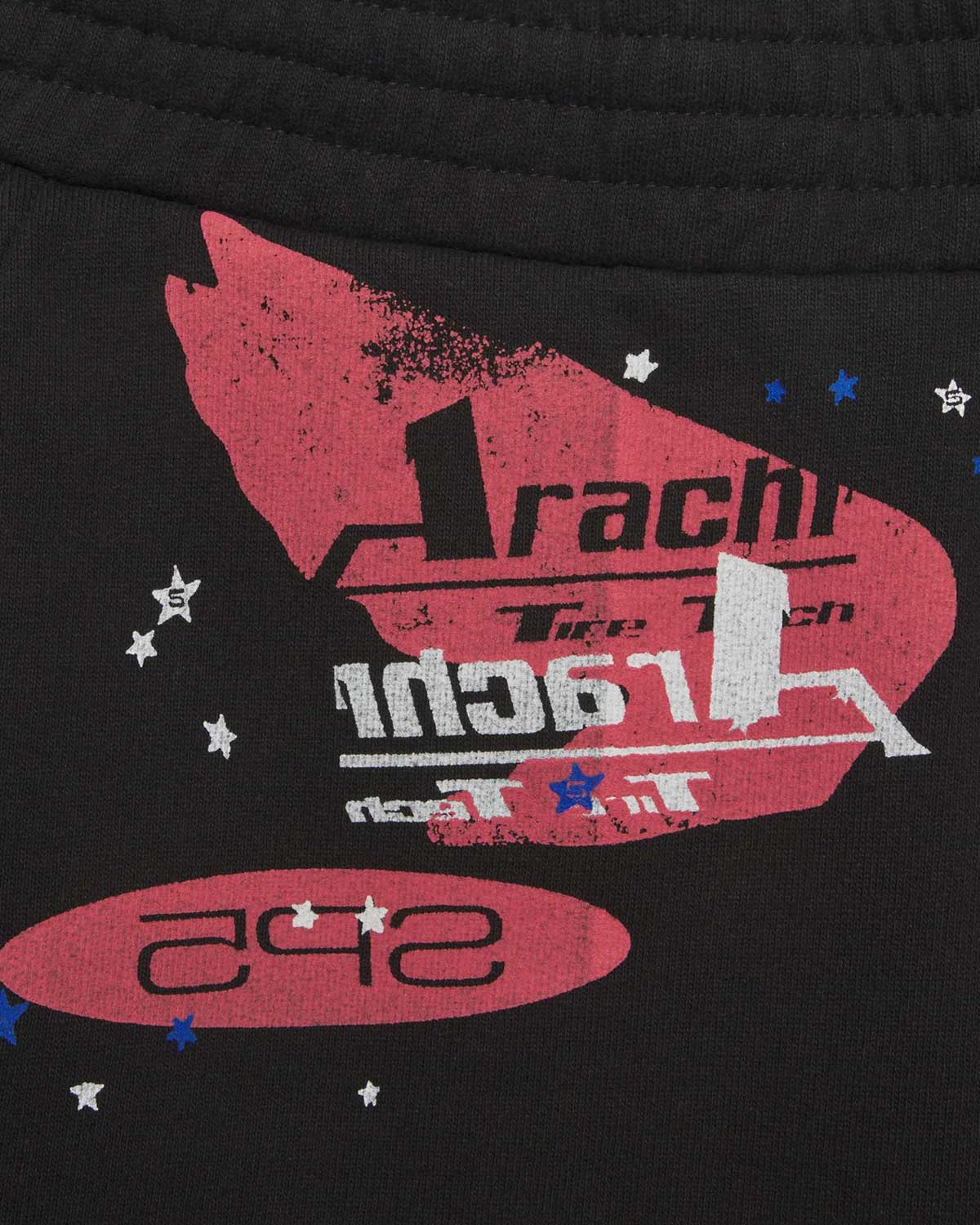 Sp5der Tire Tech Sweatshorts black, close-up of the red winged Arachnid Tire Tech badge