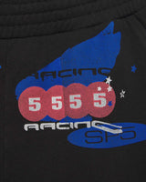 Sp5der Tire Tech Sweatshorts black, close-up of the blue racing wing and 5 5 5 5 pill graphic