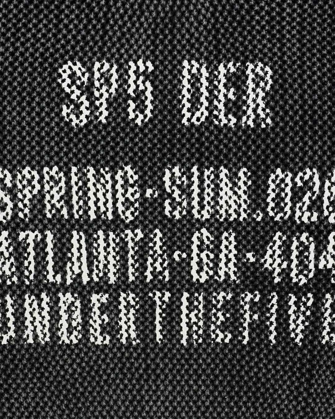 Sp5der Underthefive Sweater black, close-up of the knitted SP5 DER, Spring-Sum.026 and Atlanta-GA-404 text