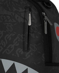 Sprayground 4AM Red Shark Backpack, close-up of the debossed dollar-sign print