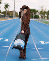 Sprayground Sharks On Iceberg Backpack, worn by a model