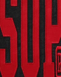 Supreme Stretch S/S Top black, close-up of the red arched chest print