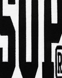 Supreme Stretch S/S Top white, close-up of the black arched chest print