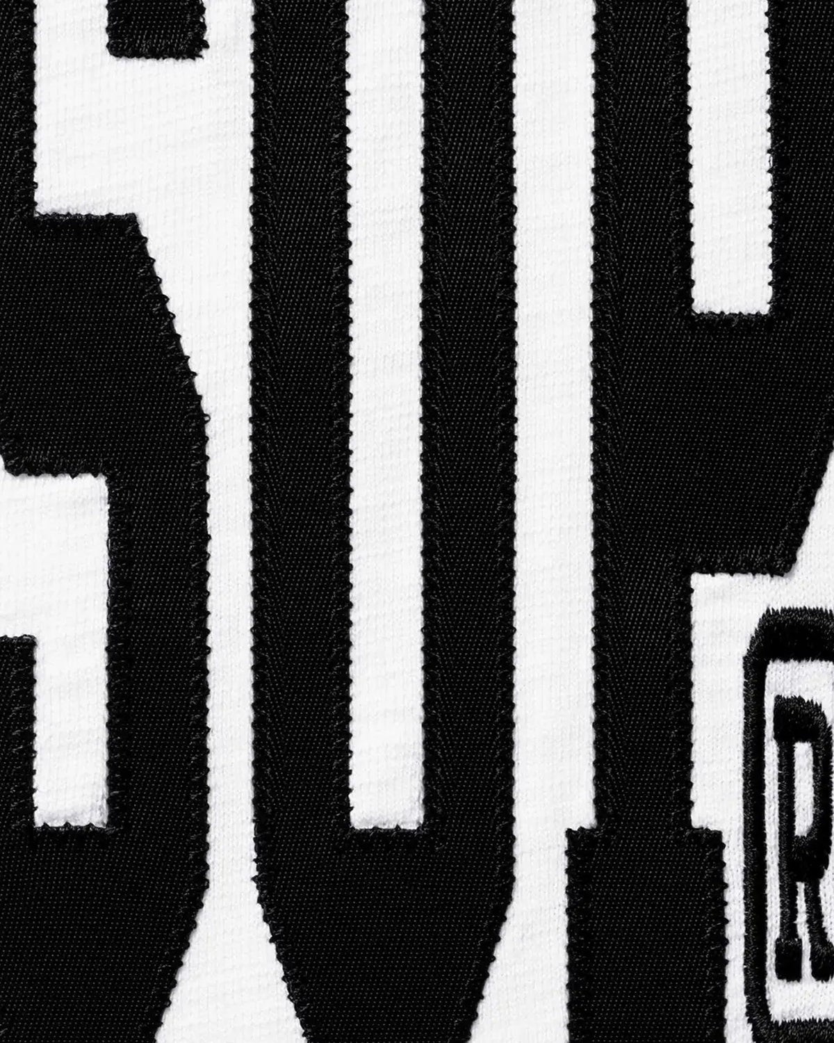 Supreme Stretch S/S Top white, close-up of the black arched chest print