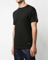 Supreme x Hanes Tagless Tee black 3 pack, worn on model showing the red Supreme hem tab