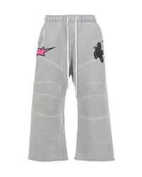 Triple Sevens Moto Sweatpants grey, wide-leg sweatpants with pink star patch and rider graphic, front view