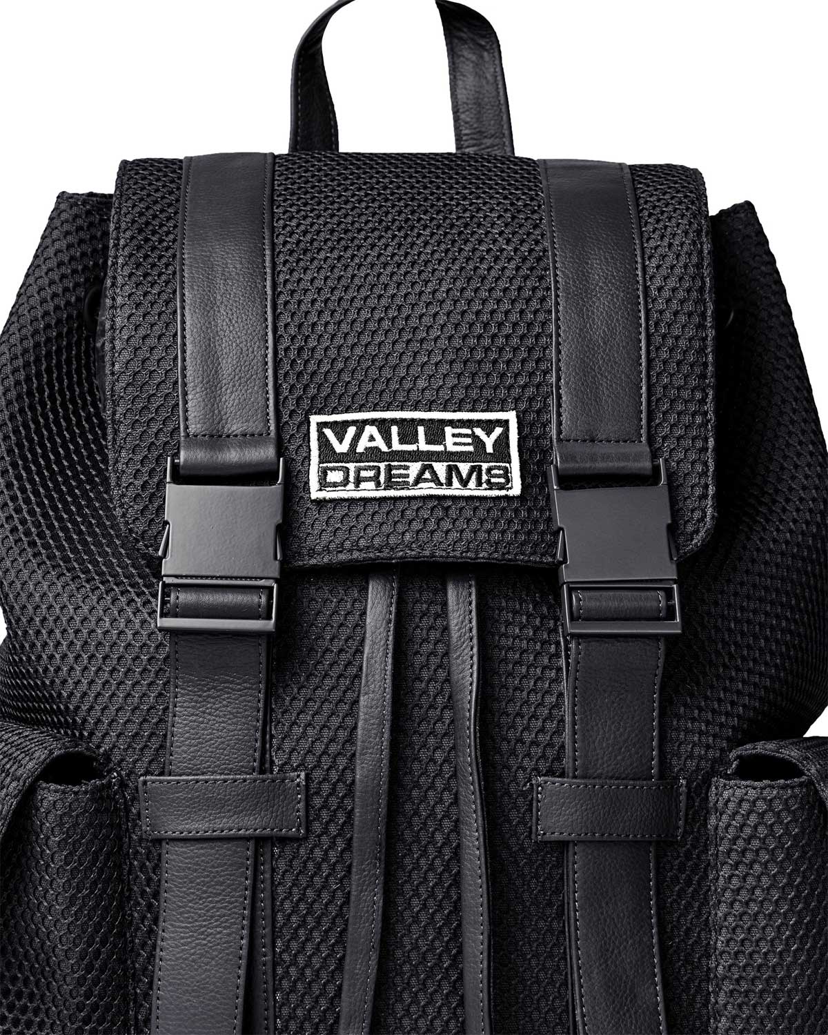 Vale Forever Black Ops Backpack black, close-up of the Valley Dreams metal plate and buckled straps
