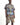 A male model wearing a matching graphic t-shirt and camouflage shorts set with colorful street-art style prints and graffiti details, photographed against a plain white studio background.