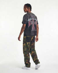 Model wearing Boredom Kills Double Pants camo, back view showing denim yoke and camo legs