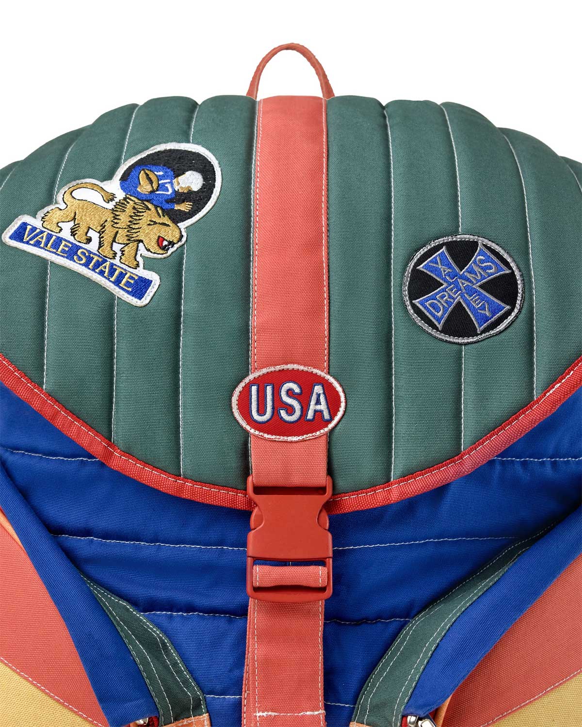 Vale Forever Diegos Backpack multicolor, close-up of the quilted flap, patches and USA buckle plate