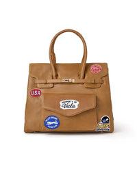 Vale Forever Lucky Charms Bag tan, tan leather top-handle bag with Property of Vale, USA and Valley Dreams patches, front view