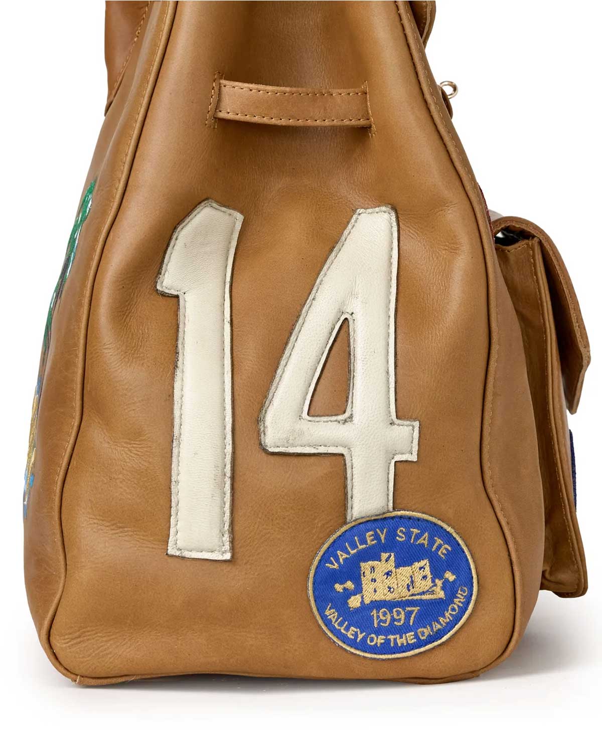 Vale Forever Lucky Charms Bag tan, close-up of the white appliqué 14 and blue Valley State 1997 embroidered patch