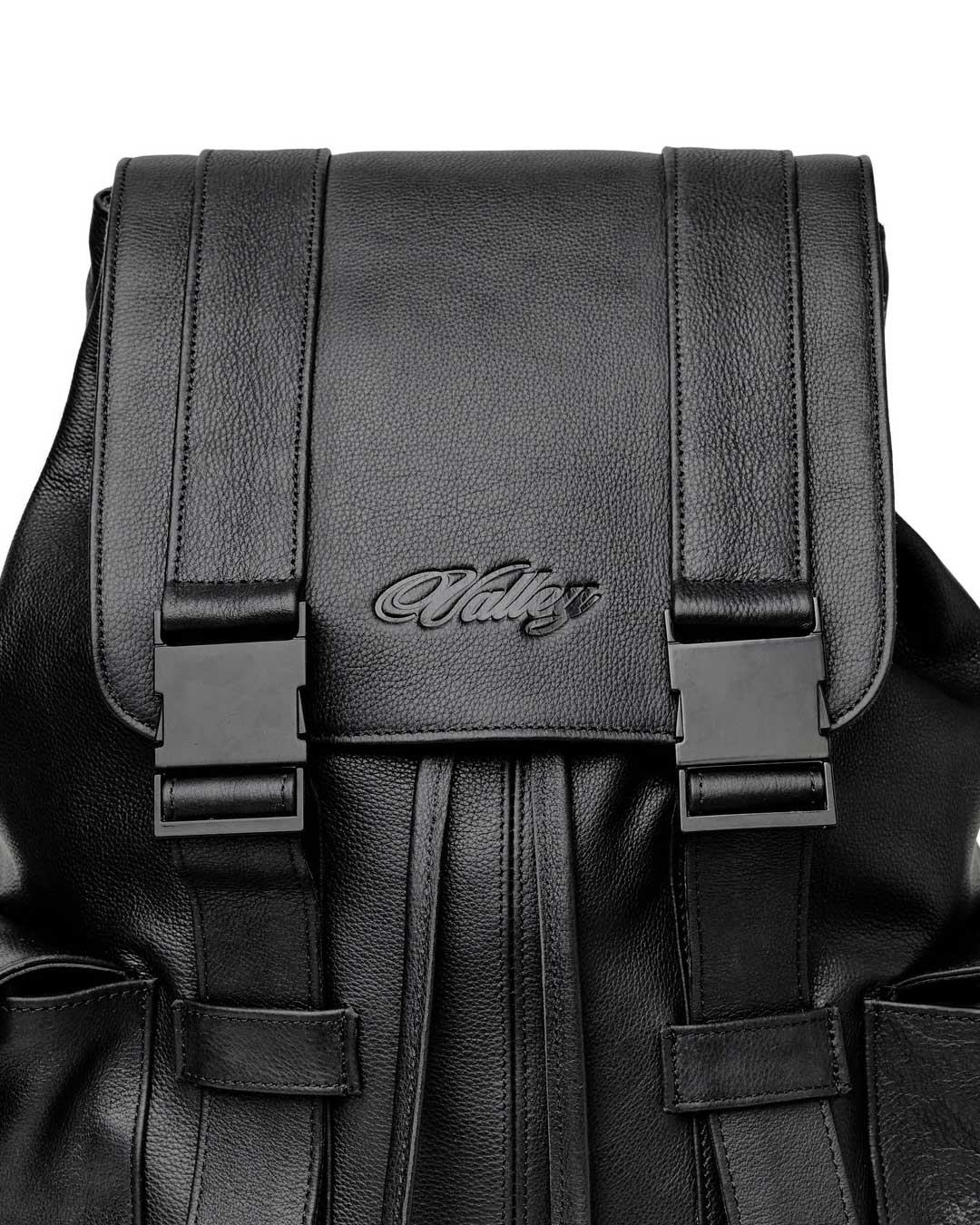 Vale Forever Tactician Backpack black, close-up of the embossed Vale script and buckle straps