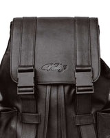 Vale Forever Tactician Backpack chocolate, close-up of the embossed Valley script and buckle hardware on the flap