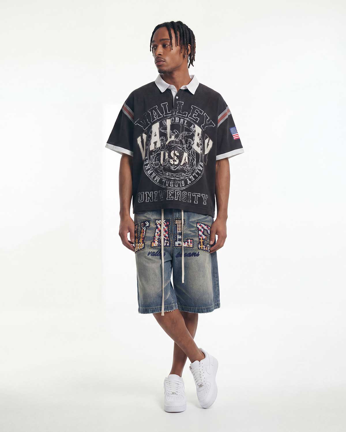 Model wearing Vale Forever USA Rugby Polo Tee black with denim shorts, full front view