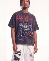 A man wearing a faded black graphic t-shirt with a cartoon character and the text 'ALE WORLD' on the front, paired with white sweatpants, against a plain white background.