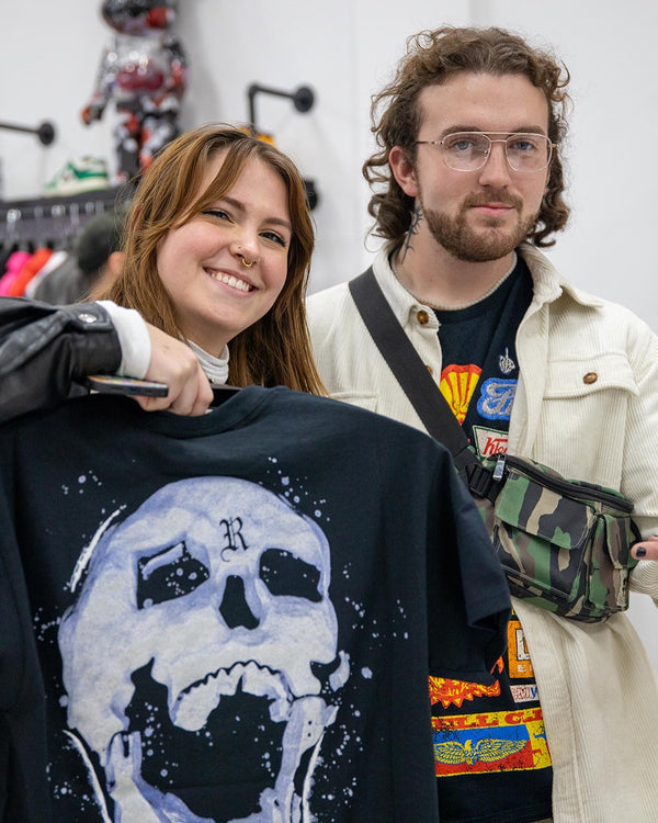 Customers holding an authenticated tee in the Restock AR store